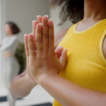 A girl practicing yoga in a group session