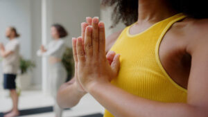 A girl practicing yoga in a group session